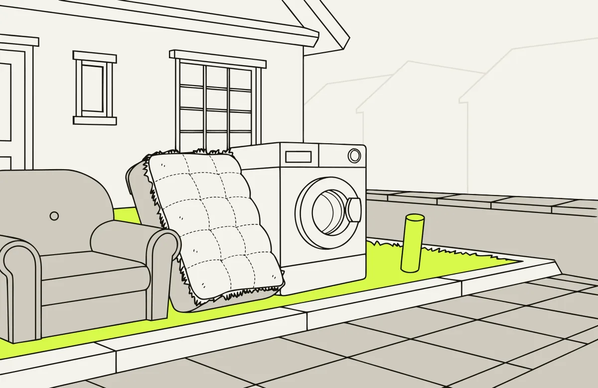 An armchair, a mattress and a washing machine set out at the curb for bulk pickup.