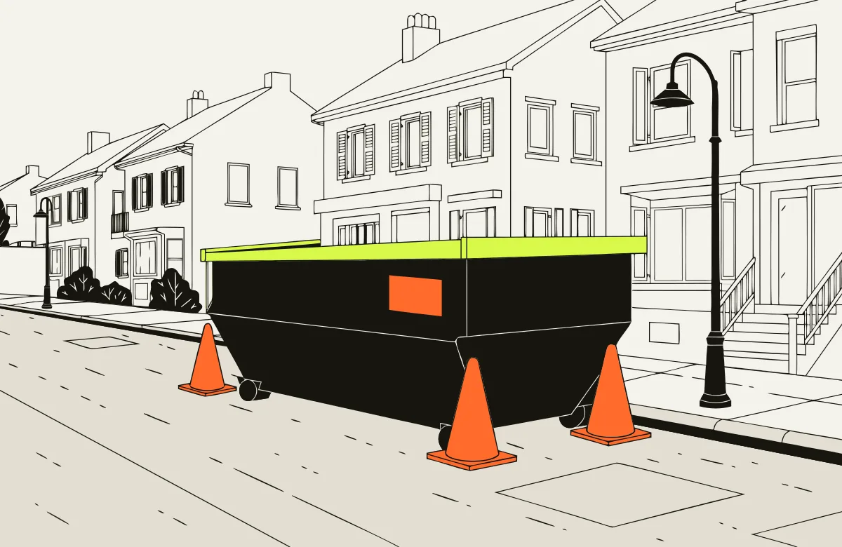 Roll-off dumpster parked on a residential street by the curb with traffic cones and a permit tag.